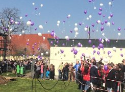 Das Bild zeigt Gäste beim Richtfest, die farbige Luftballons steigen lassen