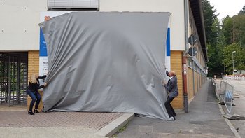 Das Bild zeigt Bürgermeister Thomas Krimm und Bundestagsabgeordnete Andrea Lindholz beim Enthüllen der Bautafel