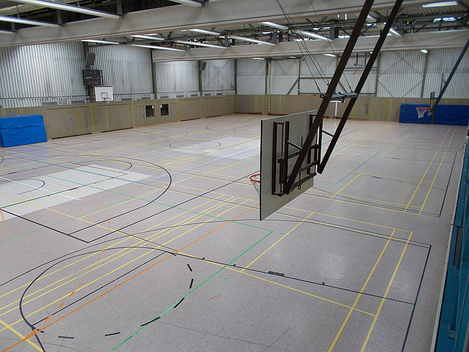 Das Bild zeigt eine Sporthalle von der Perspektive der Zuschauerränge.