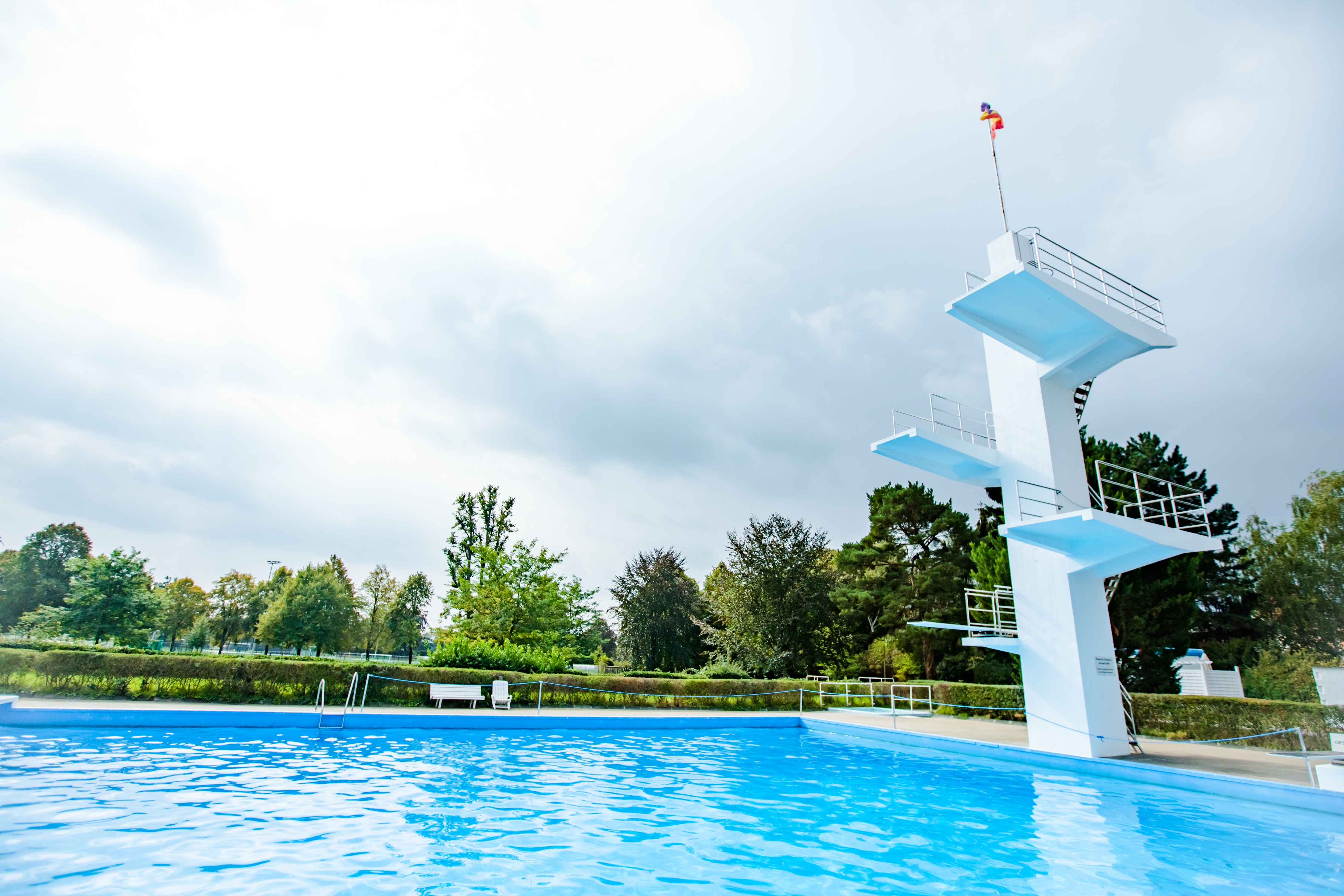 Das Bild zeigt ein Freibad mit Sprungturm.